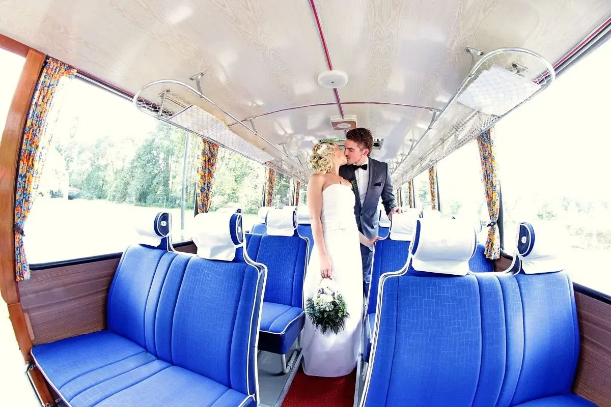 Küssendes Brautpaar im Oldtimerbus 